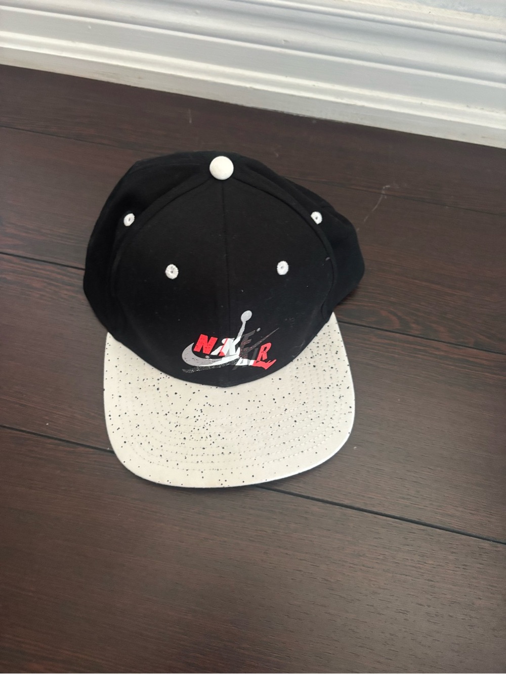 Nike Kids Black Cap with White Speckled Brim and Red Logo